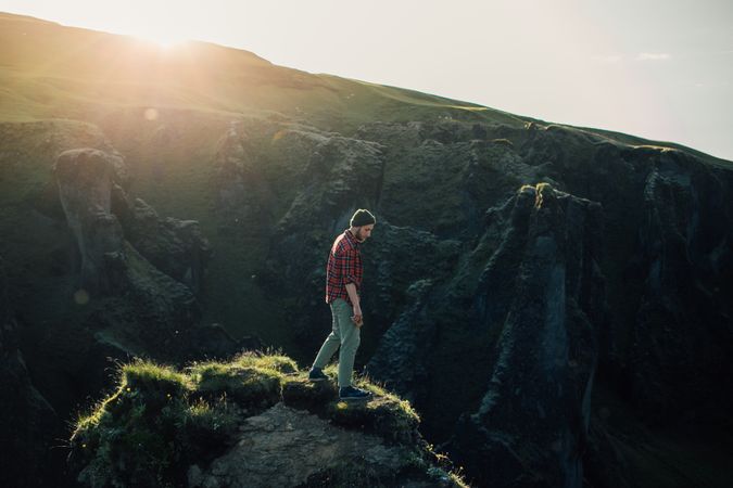 Man relaxing on edge of cliff