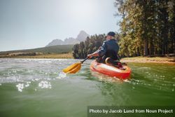 Rear view of a mature man canoeing in a lake 4Bvqx4