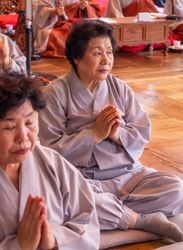 Seoul, South Korea - August, 08 2017: Elderly Asian women praying in temple
