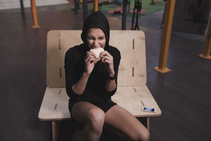 Smiling woman with rice cakes in gym