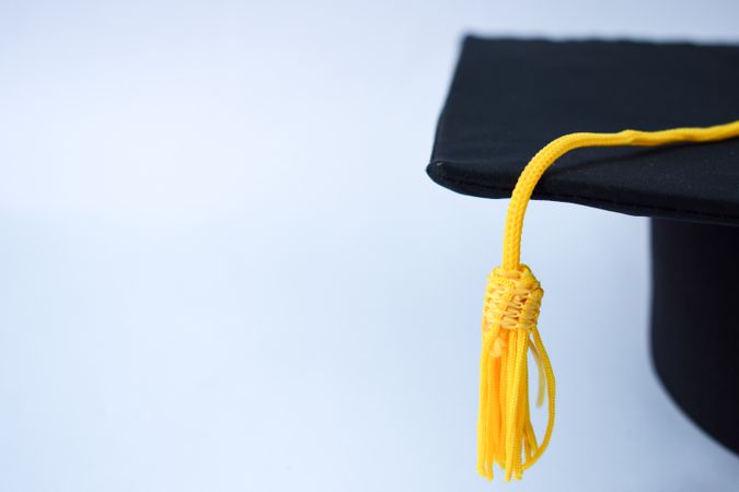 Graduation cap with tassel in studio shoot with space for text