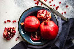 Pomegranates in blue bowl with navy napkin