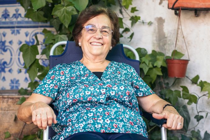 Calm older woman in patio chair