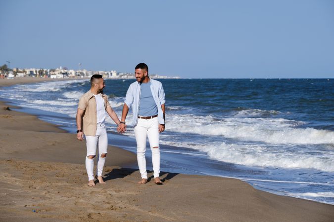 Gay couple walking on beach