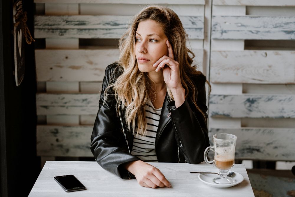 Woman using smartphone at table