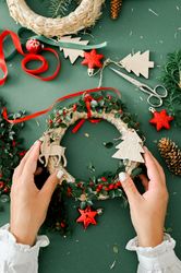 Woman holding Christmas wreath in hands