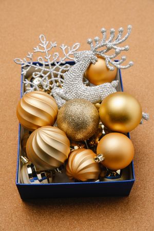 Top view of Christmas gold baubles in blue box