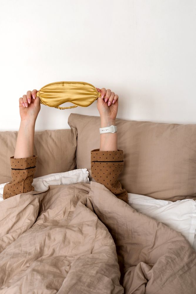 Hands up with sleep mask and smartwatch