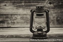 Antique lantern on old wooden table 419xO4