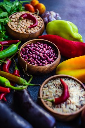 Fresh vegetables, legumes and beans on stone background with copy space