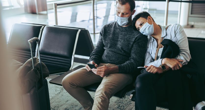 Bored tourist couple stranded in airport during pandemic