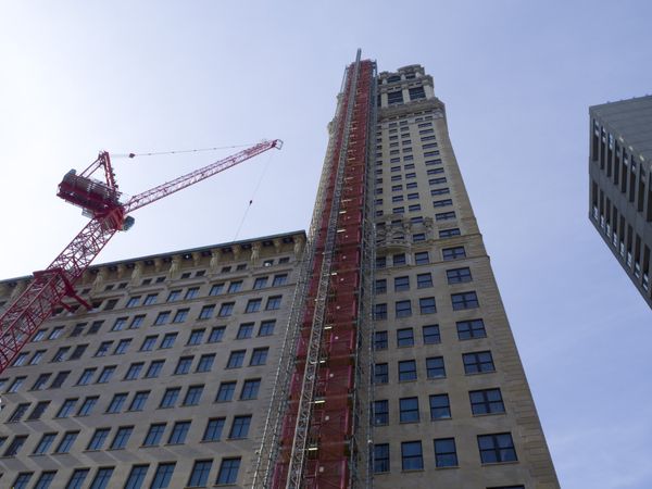 Red crane beside a building