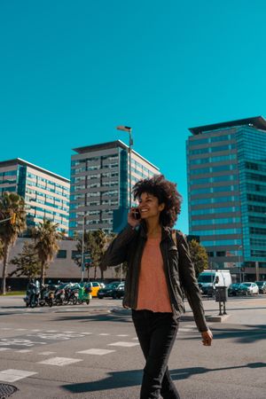 Woman with afro hair walking through the streets