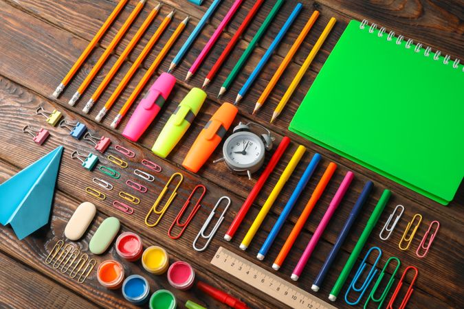 Flat lay composition with school supplies on wooden background