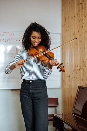 Woman playing violin in studio