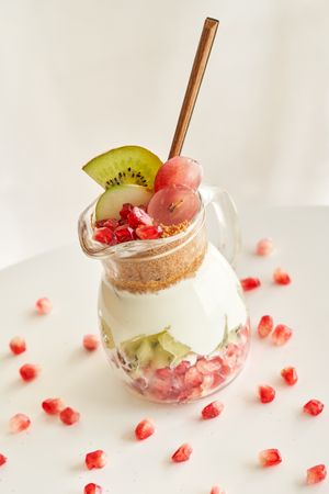 Delicious yogurt dessert with pomegranate, kiwi, grape and ginger biscuit