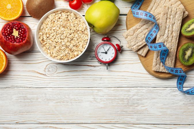 Weight loss accessories on wooden background, top view