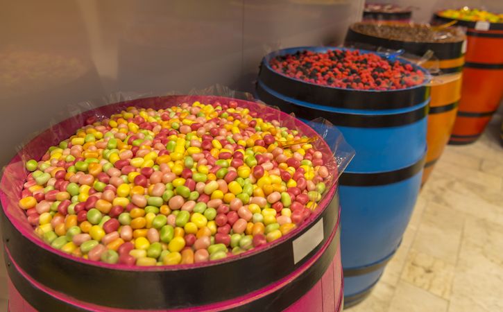 Colorful sweets in wooden barrels