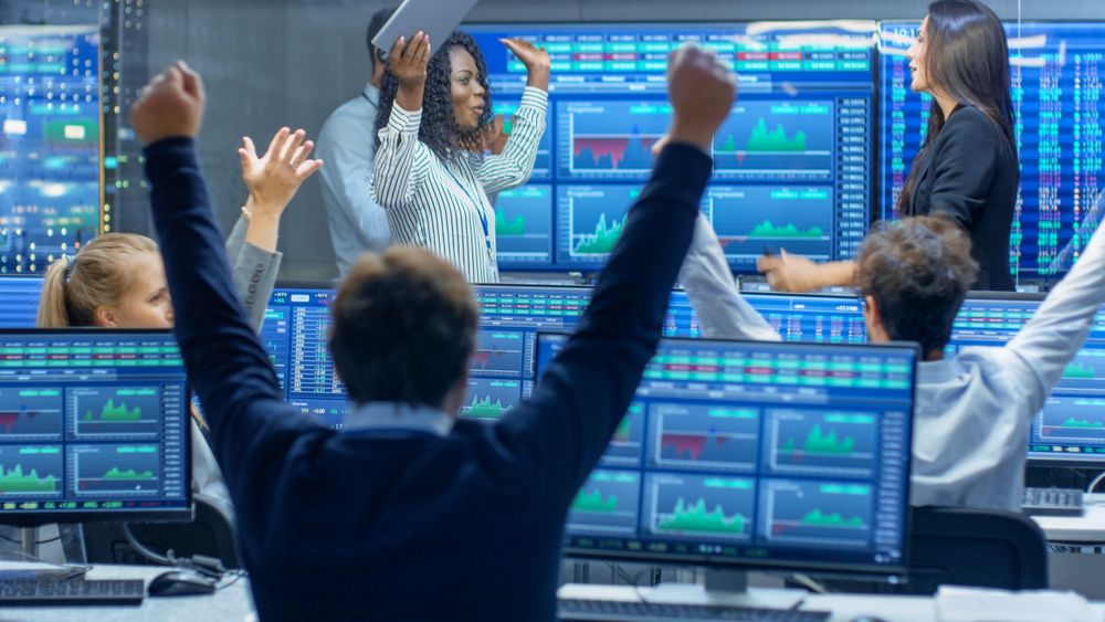 Multi-Ethnic Team of Traders Have Successful Day at the Stock Exchange Office.