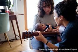 Female playing music for baby and partner 0VmBNb