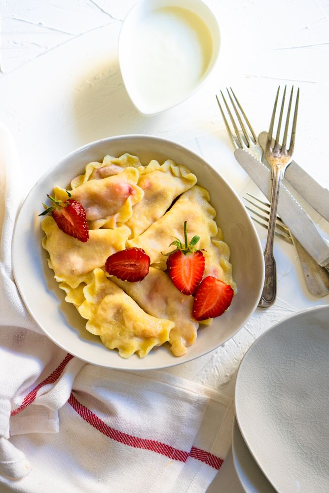 Top view of bowl of Ukrainian strawberries dumplings