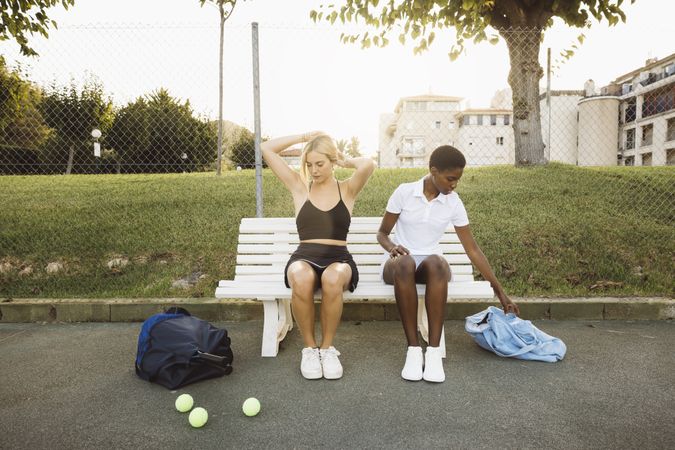 Two women getting ready before a tennis game