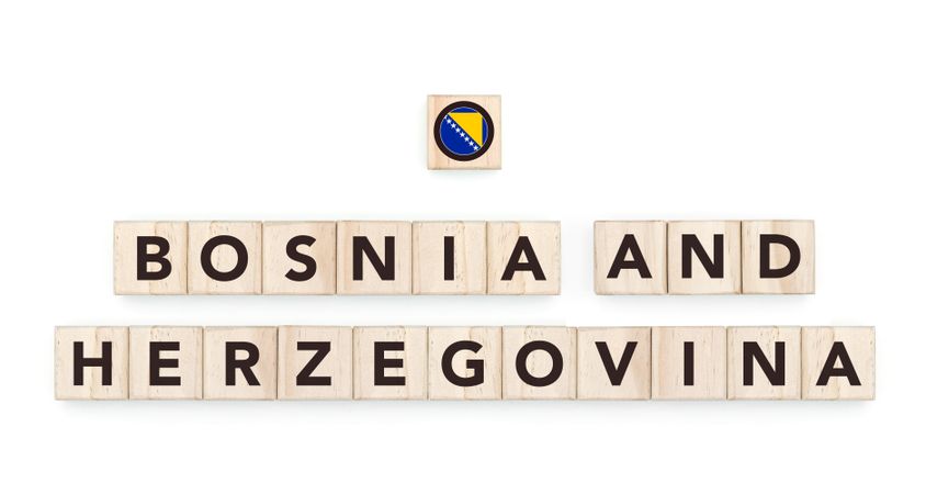 Wooden blocks bearing the name and flag of Bosnia And Herzegovina. Bosnian and European Culture, national identity, travel, and geography in a copy space design.