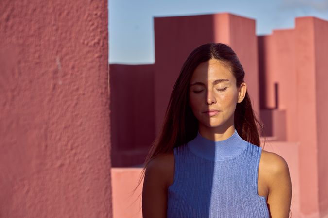 Woman with closed eyes in sunlight
