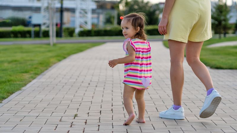 Toddler girl and mother walking