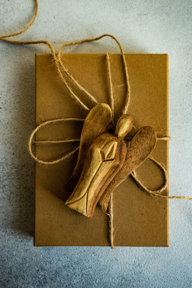 Holiday card concept with angel ornament on gift box