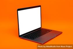 Laptop at angle with mockup screen in orange studio 48xd74
