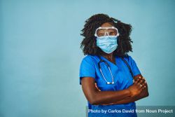 Black female medical professional wearing safety  face mask, protective eyewear and stethoscope bErgo0