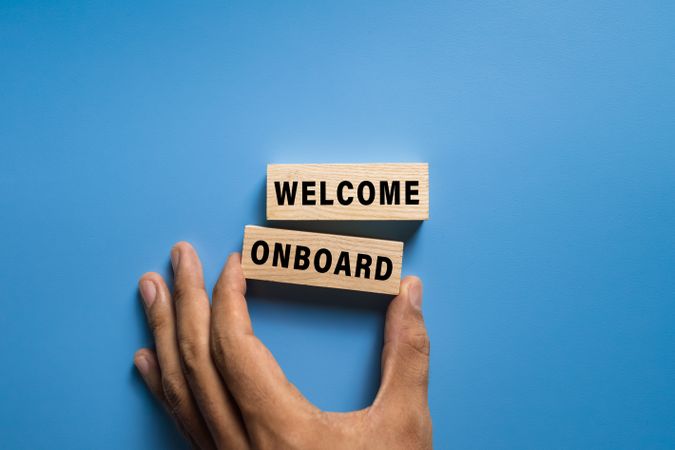 welcome onboard word text on wooden blocks isolated on blue background