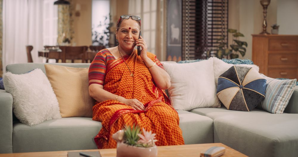 Mature Indian Woman Using Smartphone at Home