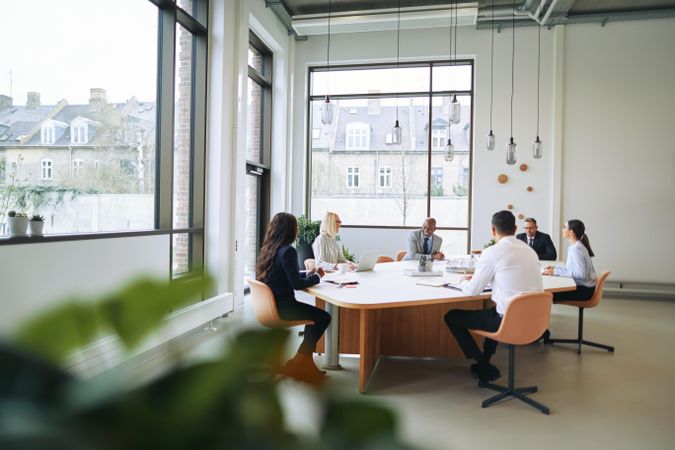 Group of people working at open desks in a bright modern office