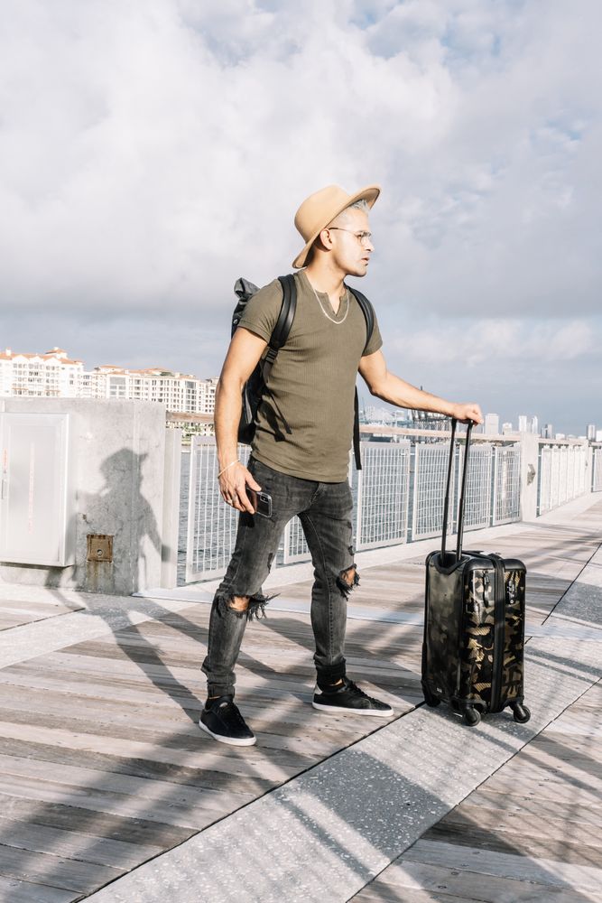 man going to summer trip and walking with his suitcase.