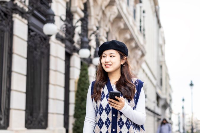 Young Asian Woman Walking and Using Smartphone in the City