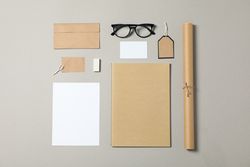 Mockup. Corporate stationery and glasses on grey background. Flat lay