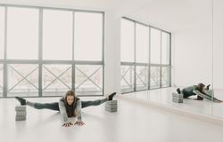 Flexible woman stretching in studio