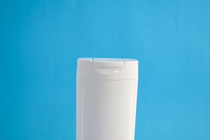 Top of blank shampoo bottle with blue background