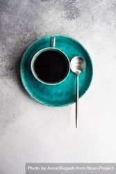 Top view of coffee cup on teal plate on marble table 5qkDZJ