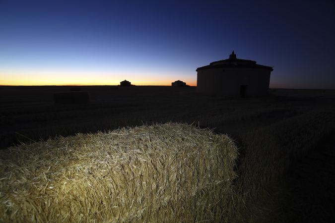 Aged house in rural countryside under starry sky