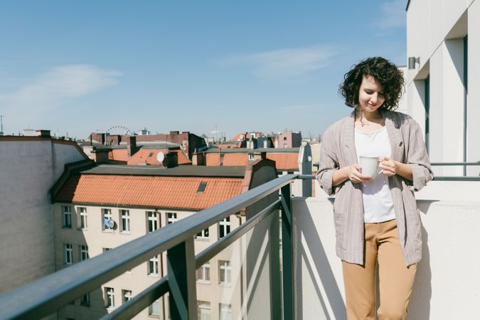 Elegant woman enjoying sun at terrace