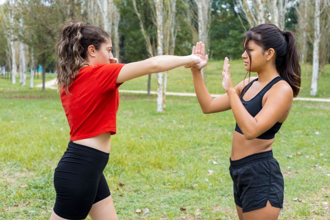 Female boxers training boxing sparring and punching  outdoors