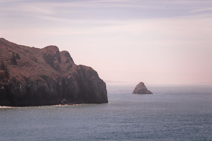 Cliff and rock in quiet waters on the West Coast