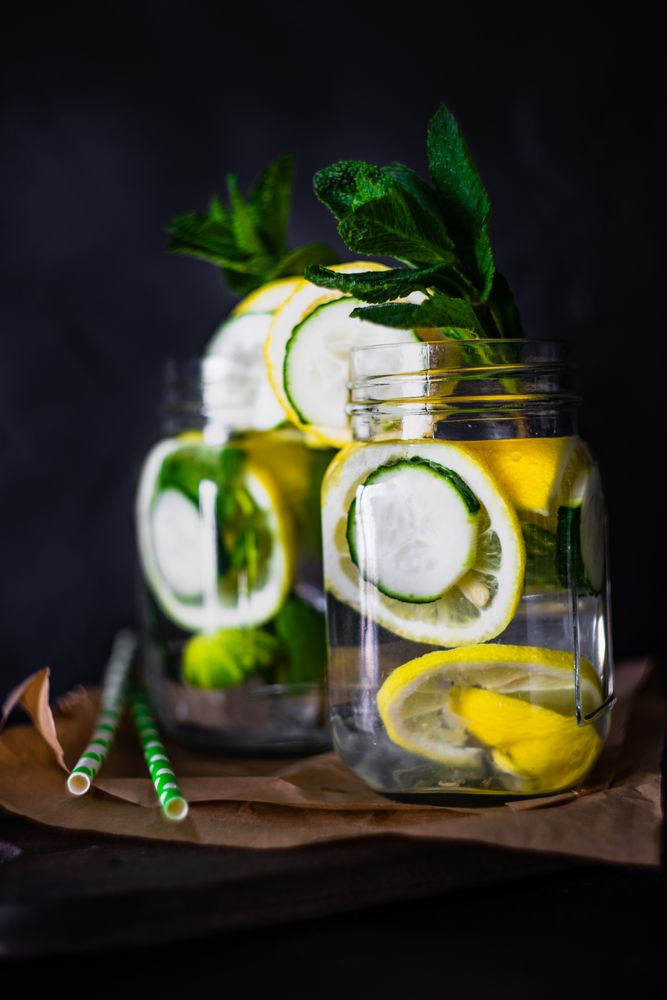 Side view of detox drink with lemon, mint and cucumber