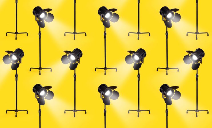 Multiple studio lamps over yellow background