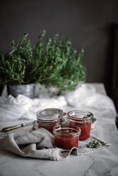 Cans with tomatoes jam on napkin