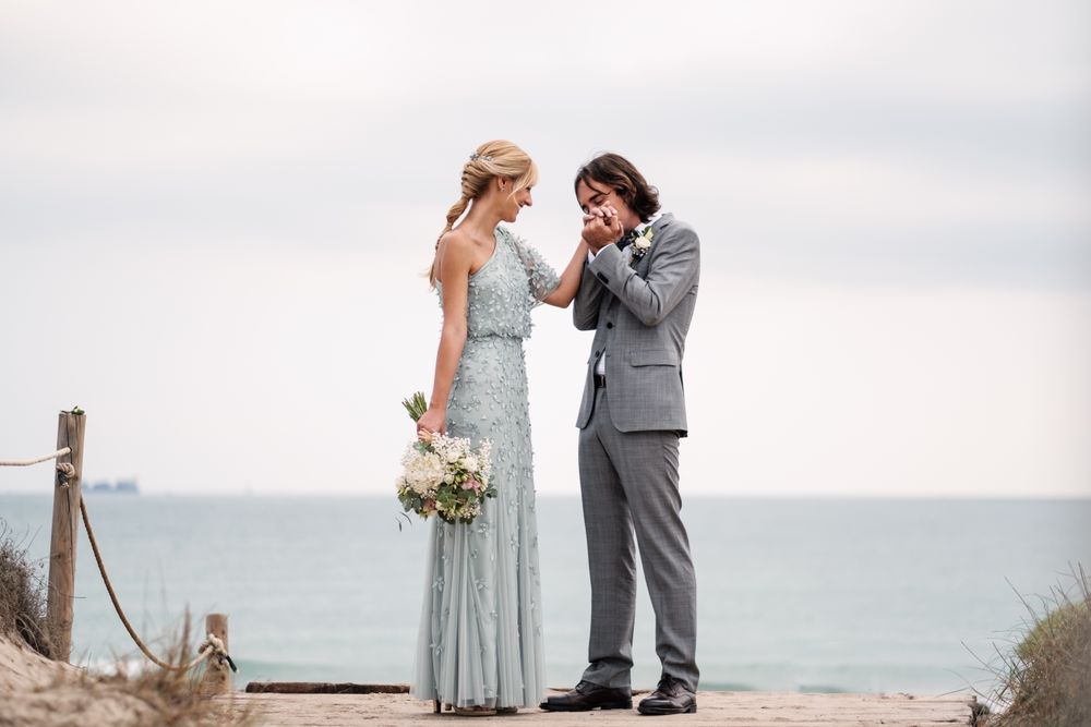 Happy young married couple spending time together at seaside