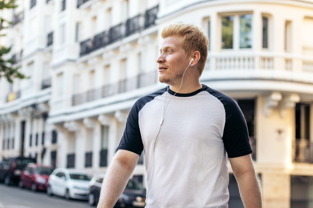 Young Latino man with albinism walking in the Madrid streets